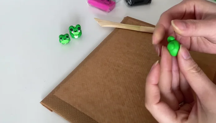 Add blush to the cheeks using a small amount of clay.