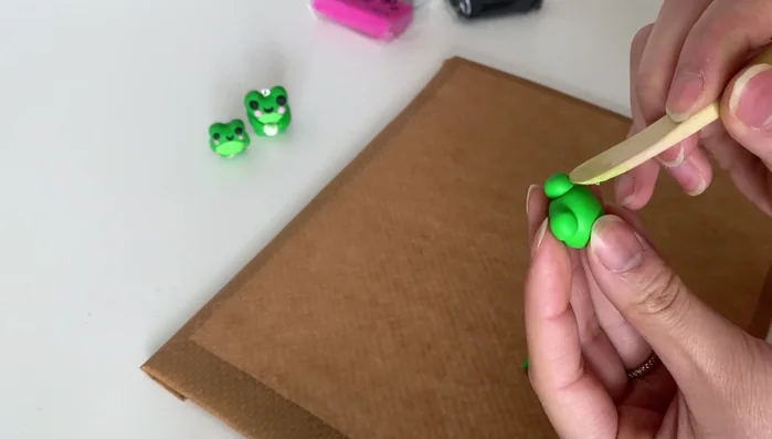 Add blush to the cheeks using a small amount of clay.