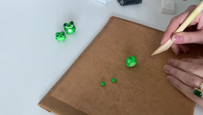 Add blush to the cheeks using a small amount of clay.