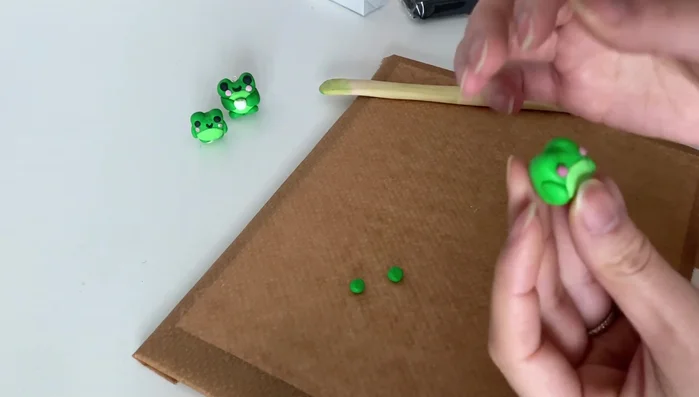 Create a tiny mouth using a small piece of black clay.