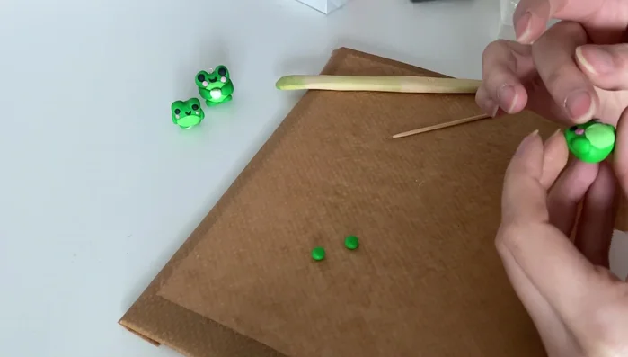 Create a tiny mouth using a small piece of black clay.