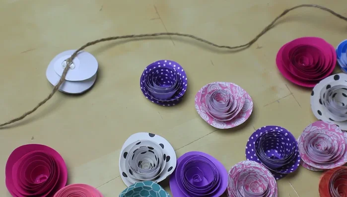 Continue gluing flowers upside down to the twine, adding felt circles to the back of each.