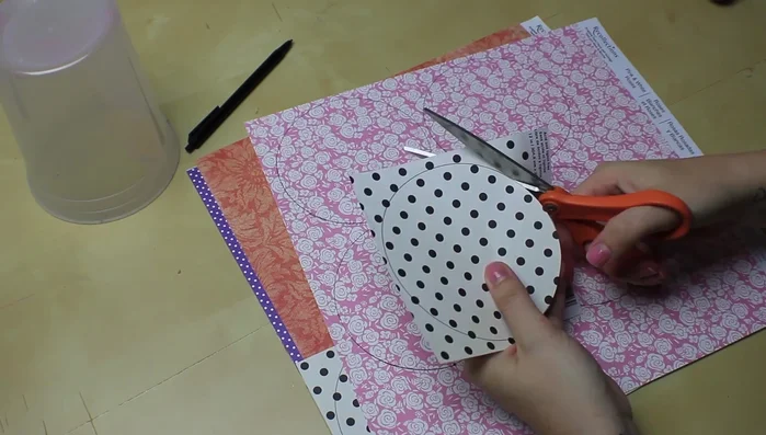 Once rolled, loosen the flower slightly to create a more natural look. Glue the tab to the center, ensuring all layers are secured with glue.