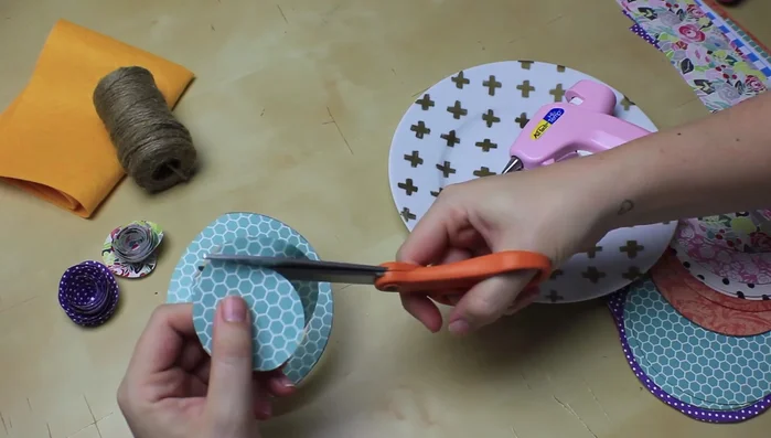 Once rolled, loosen the flower slightly to create a more natural look. Glue the tab to the center, ensuring all layers are secured with glue.