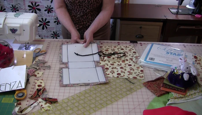 Stitch the handles down along the seam allowance.