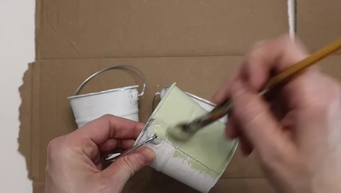 Attach the pales to the repurposed frame using hot glue.