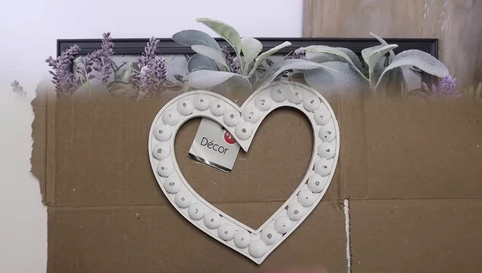 Attach a painted wooden dowel to the back of the heart.