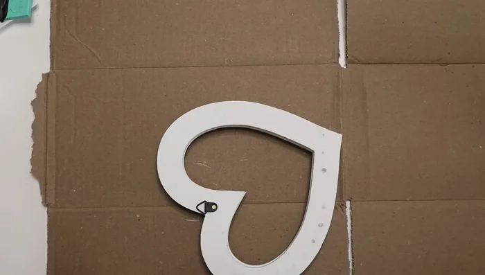 Attach a painted wooden dowel to the back of the heart.