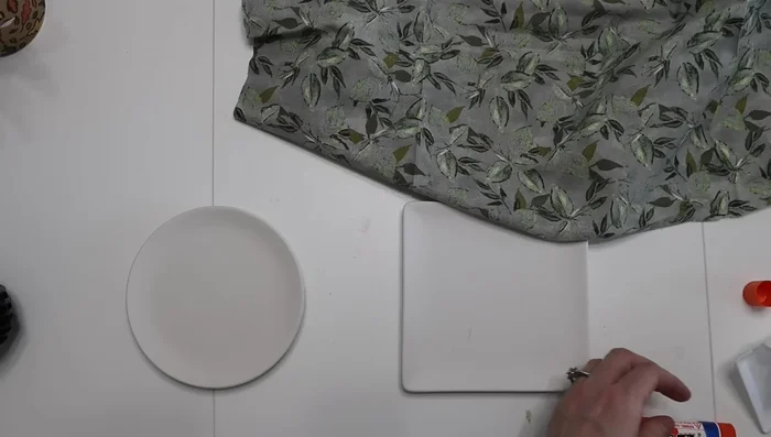 Cover the ceramic dishes with fabric using Mod Podge.