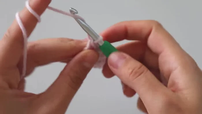 Repeat steps 2 & 3 until you reach the desired length, creating the cable pattern. The cable pattern involves making 3 double crochets, then a front post double crochet, followed by skipping a stitch and making 2 treble crochets, and repeating this sequence across the row.