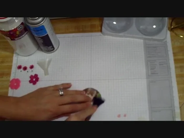 Position the photo on the ornament and peel off the clear film backing. Smooth out any wrinkles or bubbles, ensuring complete adhesion. Use a tool or fingers to gently press the image onto the ornament.