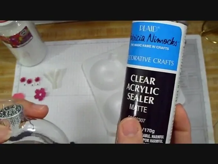 (Optional) Add glitter to the inside of the ornament using glitter glue and a funnel. Add any other desired small decorations inside the ornament before replacing the top.