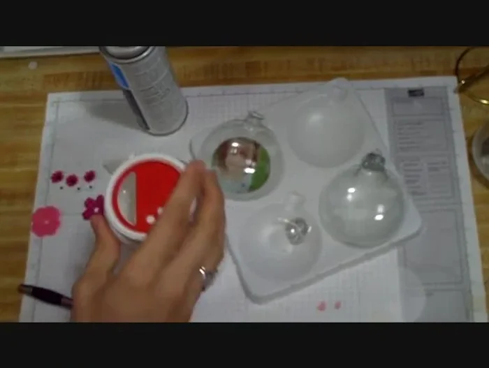 (Optional) Add glitter to the inside of the ornament using glitter glue and a funnel. Add any other desired small decorations inside the ornament before replacing the top.