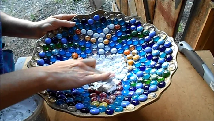 Smooth out the edges of the grout before it completely dries.