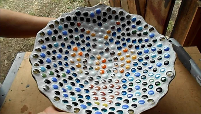 Smooth out the edges of the grout before it completely dries.