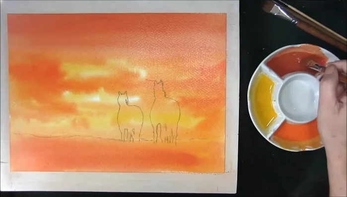 Add depth to clouds and land: Once the shine is gone from the paper (after about 10 minutes), use a #8 flat brush and stronger mixes of the colors used previously, painting darker areas in the clouds and stronger orange/red in the land.