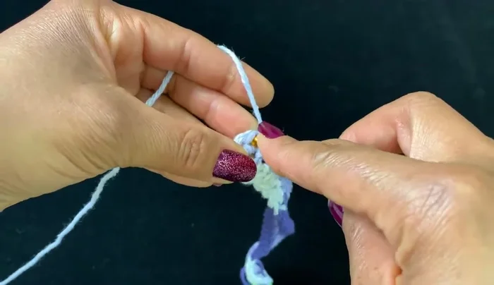 Continue round two (single crochet) until the edges meet in the middle, forming a pocket.