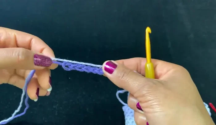 Flip the item over and secure the ring by weaving the yarn tail through several loops.
