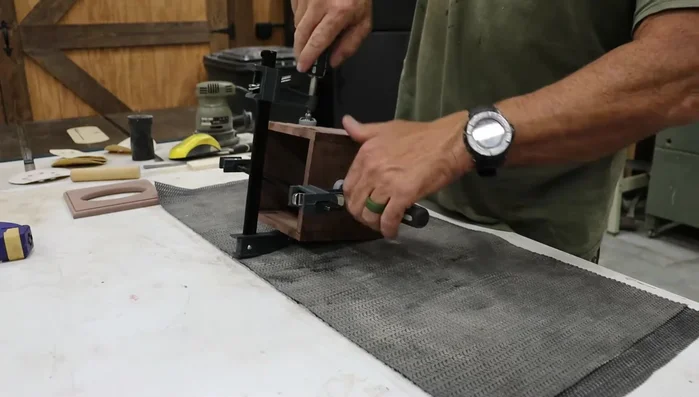 Sand the box and top: Sand the box and top with a belt sander (120 grit), then progress through the grits with a random orbital sander (150, 180, 220). Hand sand the top to 300 grit after gluing.