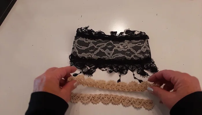 Sew a black and cream/gold fringed trim down the center of the cuff using a large zigzag stitch.