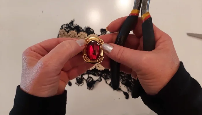 Sew short necklace pieces with beads onto either side of the earring.