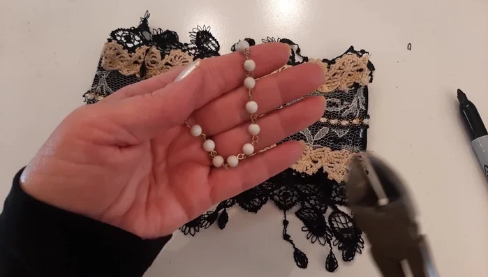 Sew short necklace pieces with beads onto either side of the earring.