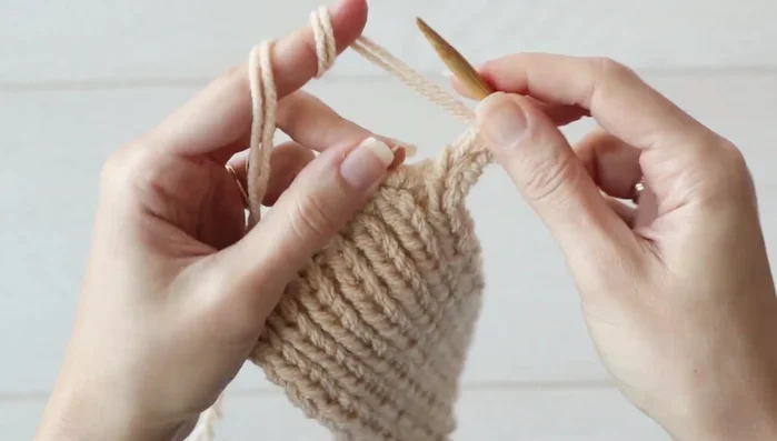 Continue working the remaining seven stitches in pattern until the piece measures 4 inches (10 cm).