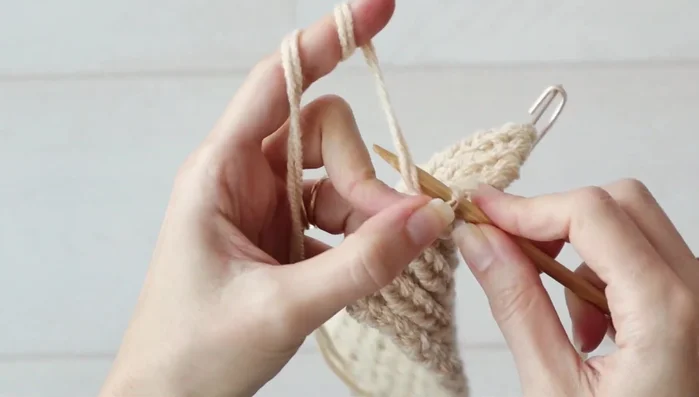 Continue working the remaining seven stitches in pattern until the piece measures 4 inches (10 cm).