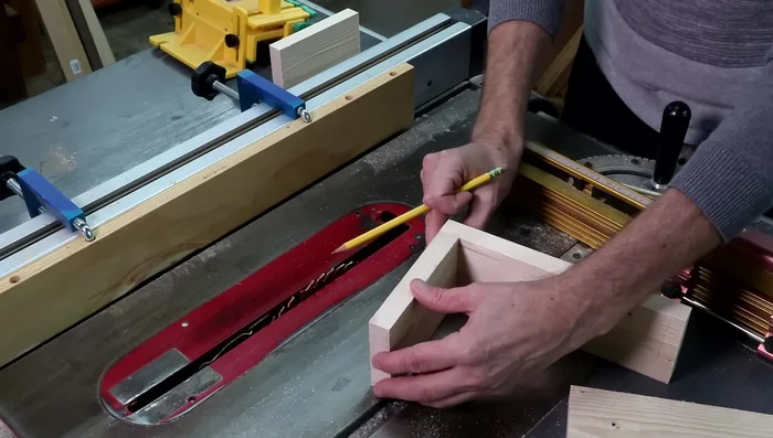 Cut the long rabbets along one long edge of each piece to hold the bottom panel, using the sacrificial fence but not the miter gauge. Make multiple passes, testing fit frequently.