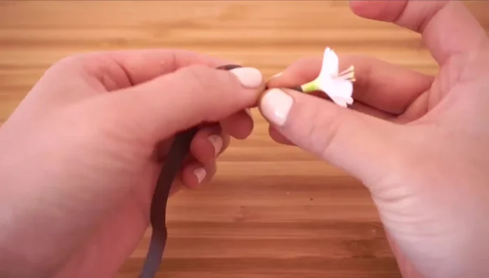 Attach to the hairband: Wrap thin strips of brown floral tape around the stem and attach the flowers to a light, velvety hairband.