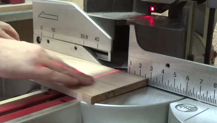 Cutting boards to desired width on table saw using a stop block.