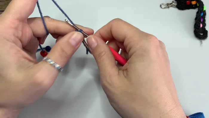 Attach the keychain ring to the yarn.