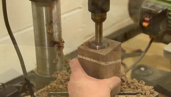 Drill a 1/2-inch hole in the center of the general purpose pencil holder using a Forstner bit.