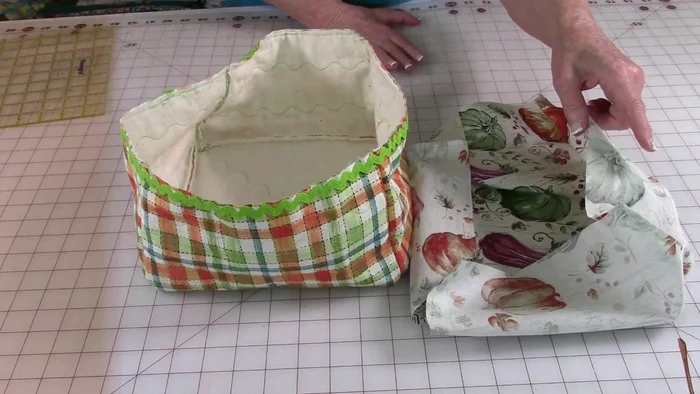 Attach lining to outer fabric: Insert the lining into the outer fabric, matching side seams. Pin and stitch along the top edge, sewing right over the rickrack stitching line.