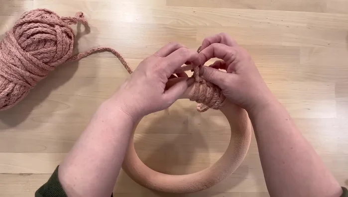 Repeat the process until the entire wreath is covered. Adjust tension as needed to create even spacing.