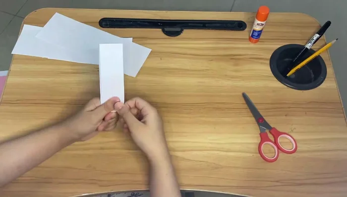 Repeat the folding process for the smaller piece of paper.