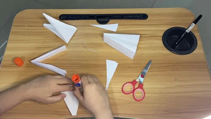 Glue the smaller pieces onto the larger pieces to form the dragon's body.