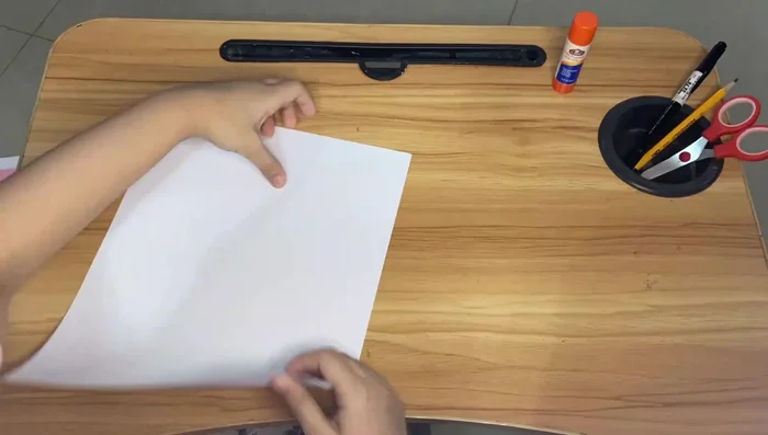 Repeat the folding process for the smaller piece of paper.