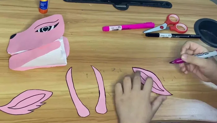 Glue the face features onto the dragon's head.