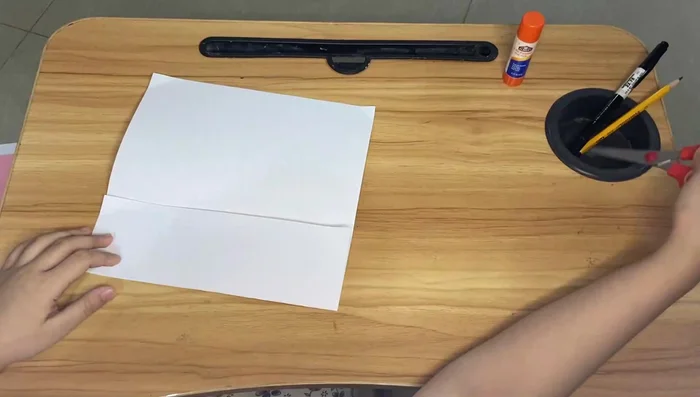 Repeat the folding process for the smaller piece of paper.