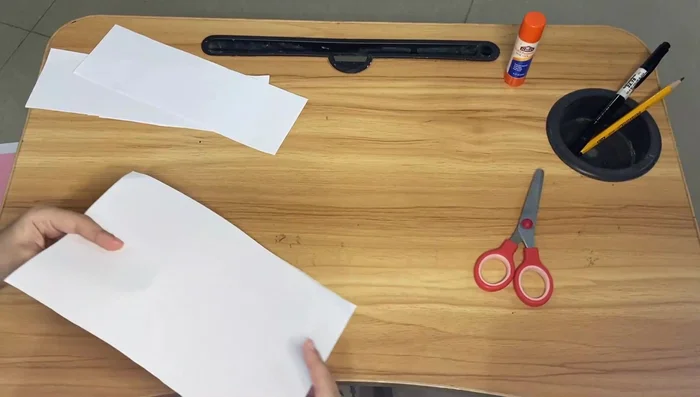 Repeat the folding process for the smaller piece of paper.