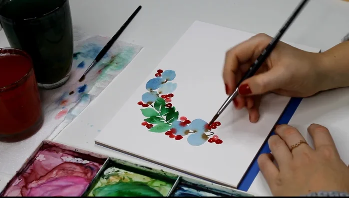 Continue adding leaves and berries, alternating colors and varying the number of leaves in each cluster.