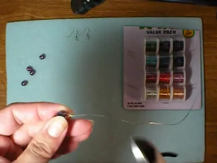 Cut the shorter wire end, leaving about an eighth of an inch above the bend.