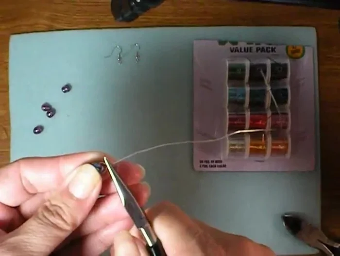 Tuck in the end of the wire and use pliers to adjust the loop as needed.