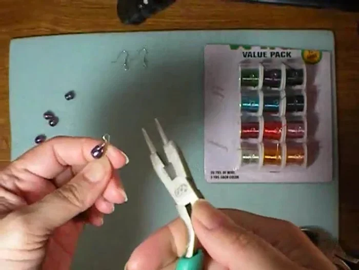 Tuck in the end of the wire and use pliers to adjust the loop as needed.