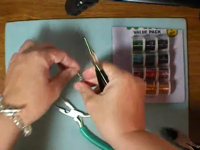 Open an ear wire, slide the loop onto it, and close the ear wire.