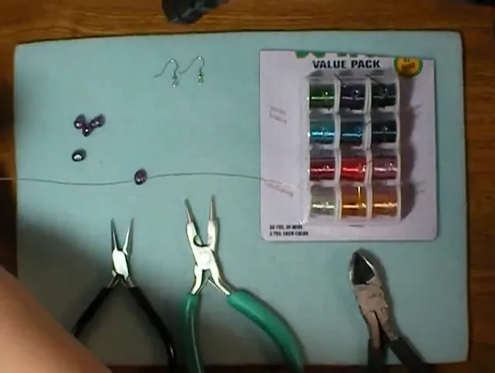 Slide a pearl onto the wire, leaving about half an inch of wire on each end.