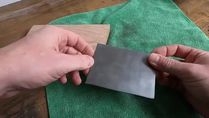 Polish the steel using Mother's polish and a buffing wheel.