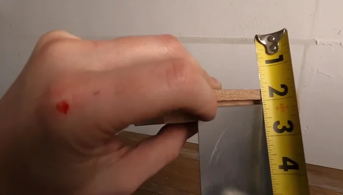Apply wood glue and super glue to secure the metal foot to the wood.