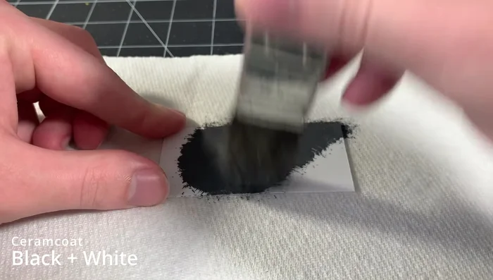 Apply a dark gray acrylic base coat to the miniature.